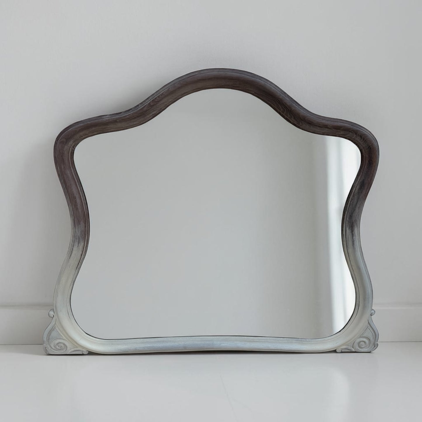 Decorative mirror with wavy frame on a white background
