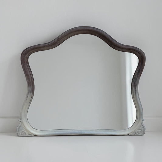 Decorative mirror with wavy frame on a white background