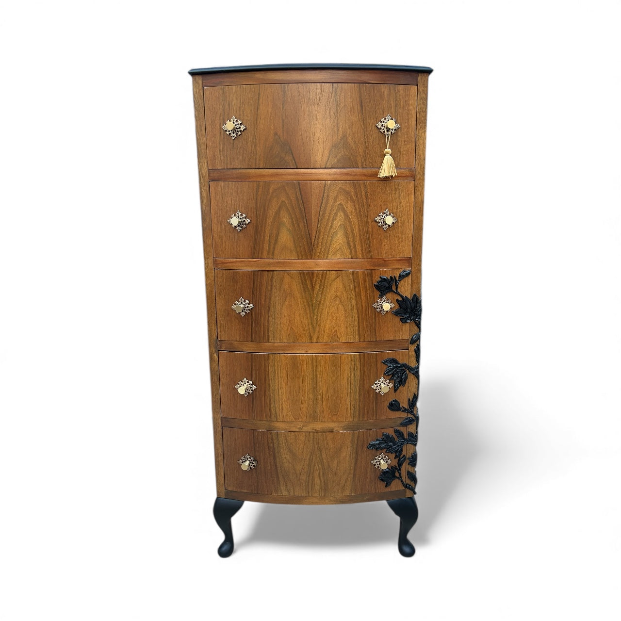 Wooden dresser with decorative floral applique on a white background