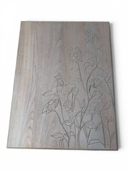 A rectangular coffee table with subtle grain texture and engraved floral line art on the right side.